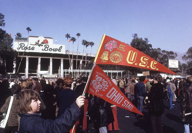 Jan 1, 1973; Pasadena, CA, USA; FILE PHOTO; A fan holds up a USC Trojans and Ohio State Buckeyes flag pendants at the Rose Bowl. Mandatory Credit: Malcolm Emmons-USA TODAY NETWORK