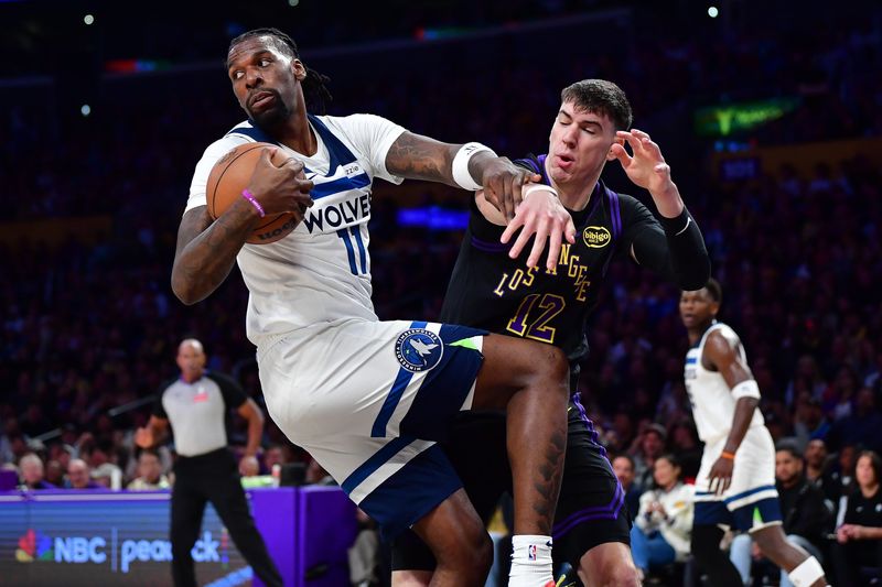Mar 10, 2026; Los Angeles, California, USA; Minnesota Timberwolves center Naz Reid (11) gets the rebound against Los Angeles Lakers forward Jake LaRavia (12) during the first half at Crypto.com Arena. Mandatory Credit: Gary A. Vasquez-Imagn Images