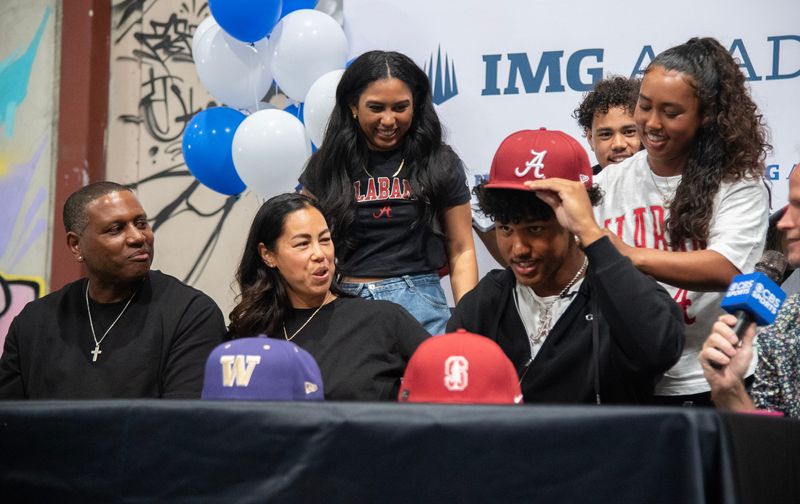 Surrounded by his family former St. Mary’s football standout Osani Gayles commits to play for the Universtiy of Alabama during a ceremony at Crossfit 209 Sport in Stockton on June 27, 2026.