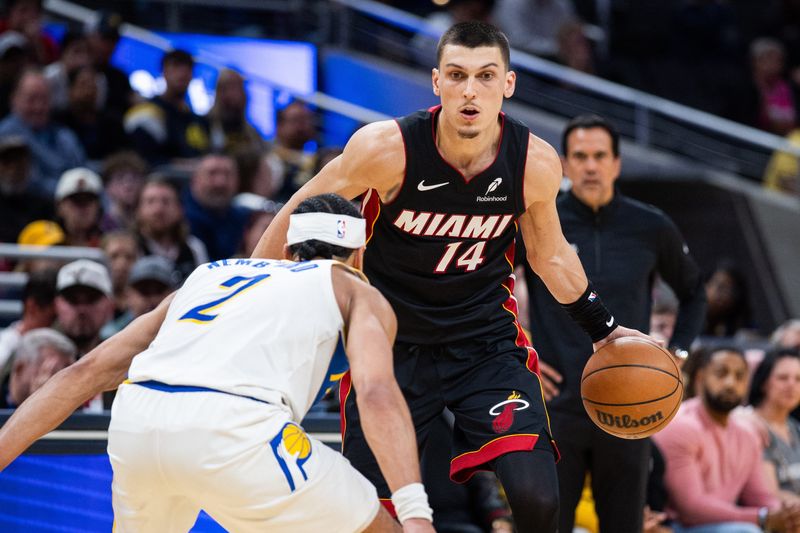 Mar 29, 2026; Indianapolis, Indiana, USA;  Miami Heat guard Tyler Herro (14) dribbles the ball while Indiana Pacers guard Andrew Nembhard (2) defends in the second half at Gainbridge Fieldhouse. Mandatory Credit: Trevor Ruszkowski-Imagn Images