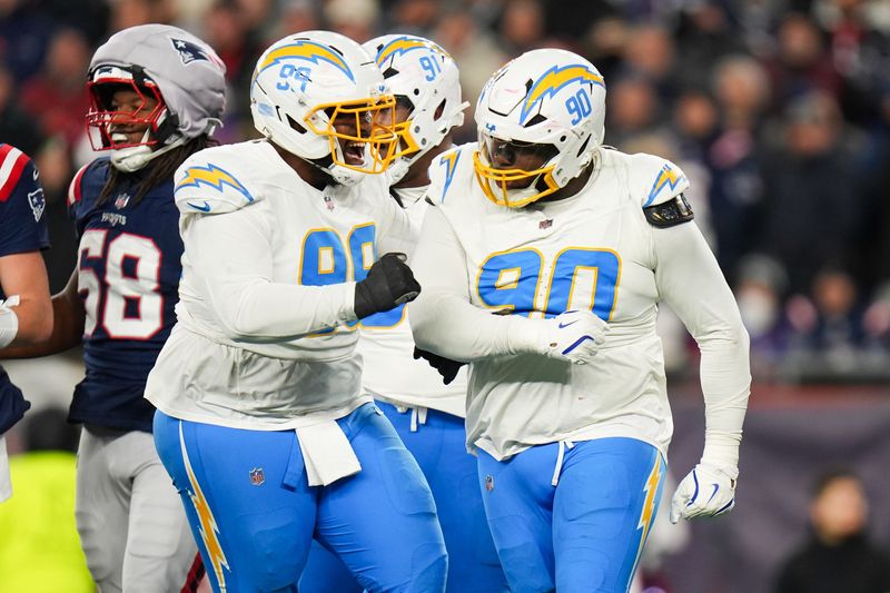Jan 11, 2026; Foxborough, MA, USA; Los Angeles Chargers defensive tackle Teair Tart (90) celebrates a sack with Los Angeles Chargers defensive tackle Jamaree Caldwell (99) during the third quarter against the New England Patriots in an AFC Wild Card Round game at Gillette Stadium. Mandatory Credit: David Butler II-Imagn Images