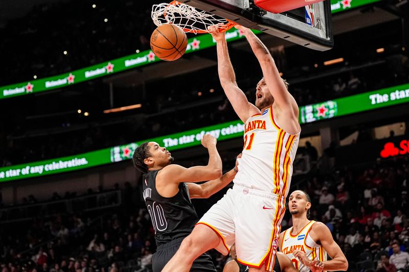 Mar 12, 2026; Atlanta, Georgia, USA; Atlanta Hawks center Jock Landale (31) dunks over Brooklyn Nets forward Josh Minott (00) during the second half at State Farm Arena. Mandatory Credit: Dale Zanine-Imagn Images