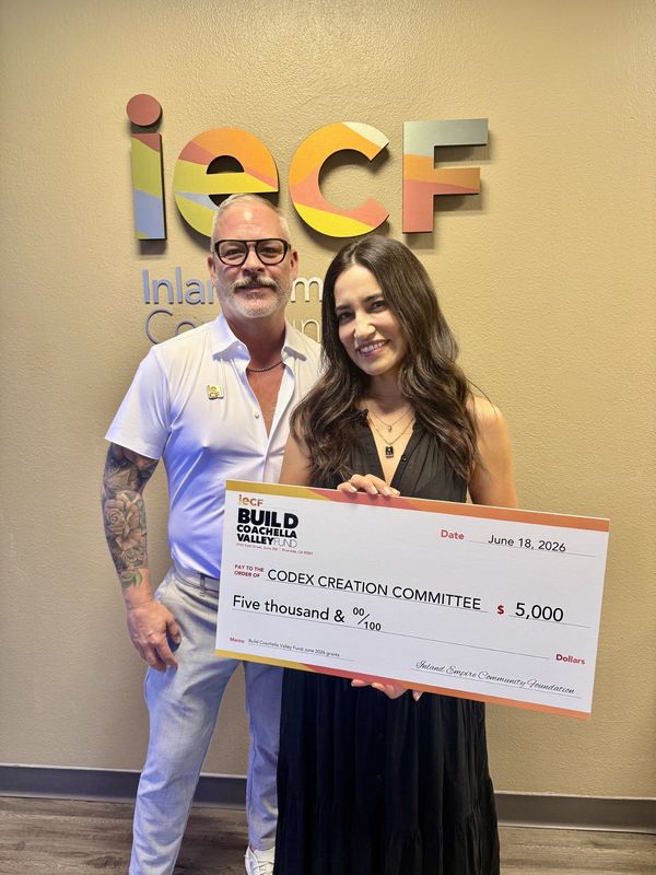 Michael Hinkle, IECF's charitable giving officer for the Coachella Valley, poses with Analisa Holoubek of the Codex Creation Committee.