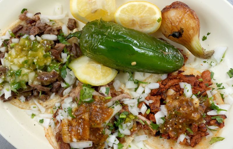 Three tacos, from left to right, carne asada, carnitas and al pastor. Photo taken at Establos Meat Market in Camarillo on July 1, 2026.
