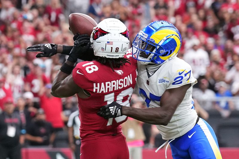 Sep 15, 2024; Glendale, Arizona, USA; Arizona Cardinals wide receiver Marvin Harrison Jr. (18) catches a touchdown pass against Los Angeles Rams cornerback Tre'Davious White (27) during the first half at State Farm Stadium. Mandatory Credit: Joe Camporeale-Imagn Images