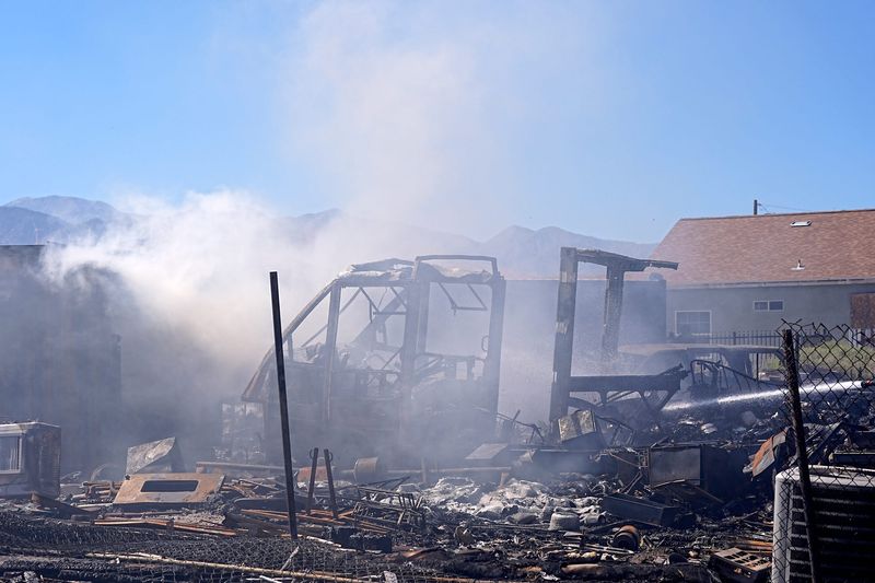 Firefighters respond to a fire involving shipping containers on a property near Windy Point in Palm Springs, Calif., on July 7, 2026.