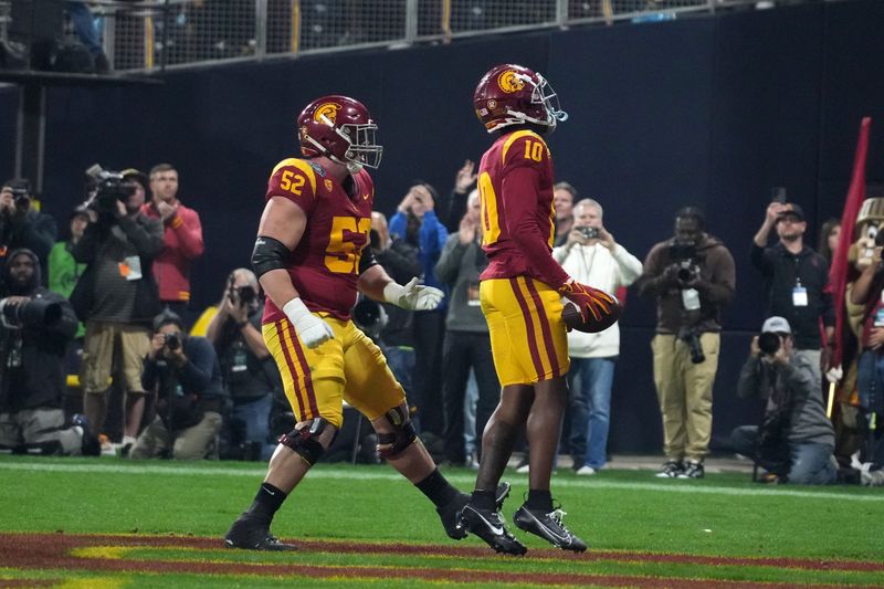 Dec 27, 2023; San Diego, CA, USA; Southern California Trojans wide receiver Kyron Hudson (10) celebrates with offensive lineman Jarrett Kingston (52) after catching a touchdown pass against the Louisville Cardinals in the first half of the Holiday Bowl at Petco Park. Mandatory Credit: Kirby Lee-USA TODAY Sports