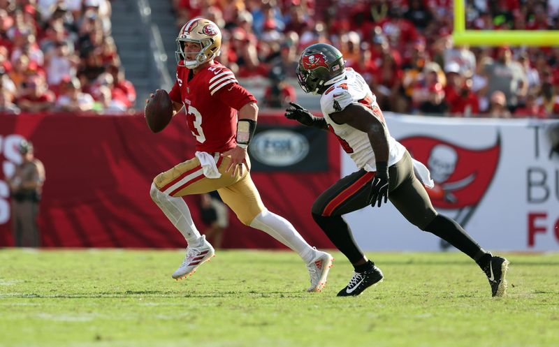 Nov 10, 2024; Tampa, Florida, USA; San Francisco 49ers quarterback Brock Purdy (13) runs out of the pocket as Tampa Bay Buccaneers linebacker Lavonte David (54) defends during the second half at Raymond James Stadium. Mandatory Credit: Kim Klement Neitzel-Imagn Images