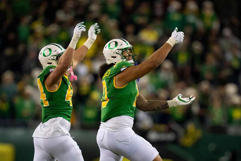 Oregon outside linebackers Matayo Uiagalelei, right, and Teitum Tuioti take the field as the Oregon Ducks host the Minnesota Golden Gophers on Nov. 14, 2025, at Autzen Stadium in Eugene, Oregon.