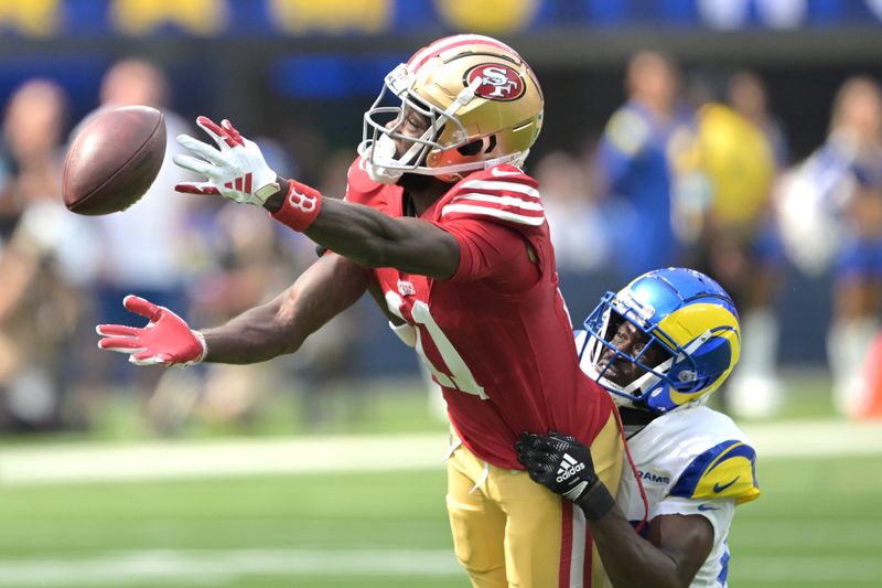 Sep 22, 2024; Inglewood, California, USA;  Los Angeles Rams cornerback Tre'Davious White (27) defends San Francisco 49ers wide receiver Brandon Aiyuk (11) on a pass play in the first half at SoFi Stadium. Mandatory Credit: Jayne Kamin-Oncea-Imagn Images