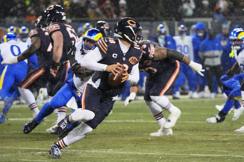 Jan 18, 2026; Chicago, IL, USA; Chicago Bears quarterback Caleb Williams (18) scrambles against the Los Angeles Rams during the first quarter of an NFC Divisional Round game at Soldier Field. Mandatory Credit: David Banks-Imagn Images
