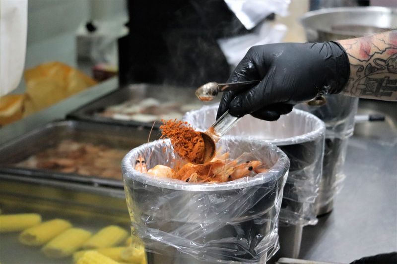 Co-owner Roy Gonzales prepares a shrimp boil for customers, which seasoned in hand-tossed spices he makes from scratch.