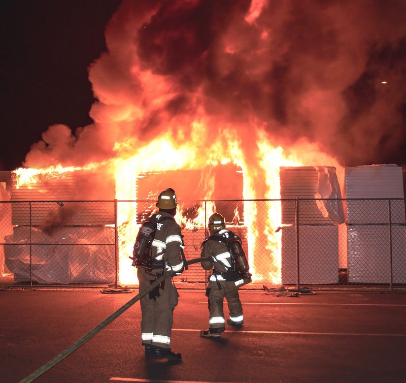 Firefighters extinguish a fire that destroyed construction material and caused around $120,000 of damage at Fillmore High School on July 4, 2026.