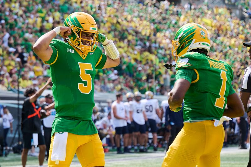 Aug 30, 2025; Eugene, Oregon, USA; Oregon Ducks quarterback Dante Moore (5) celebrates with wide receiver Dakorien Moore (1) after a touchdown scored by wide receiver Gary Bryant Jr. (2) during the second half against the Montana State Bobcats at Autzen Stadium. Mandatory Credit: Troy Wayrynen-Imagn Images