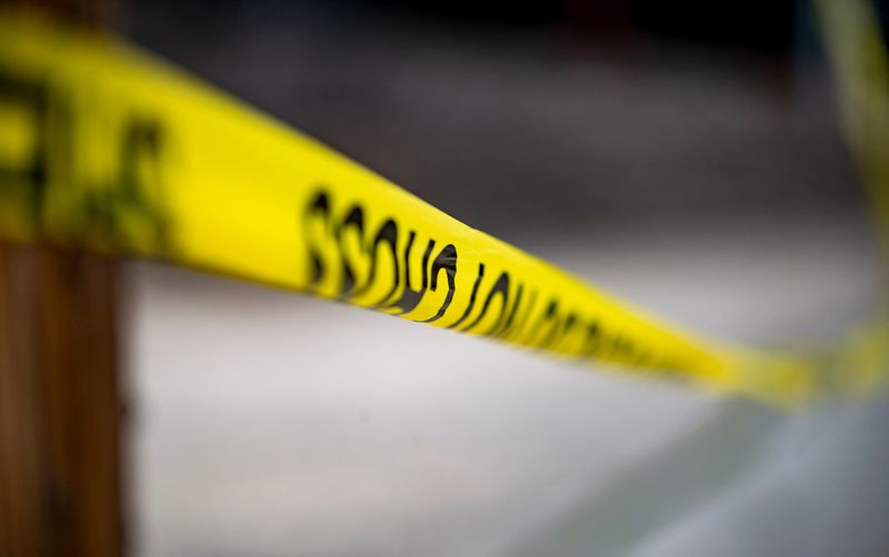 Police tape marks the perimeter of an officer-involved shooting scene July 15, 2026, in Asheville. One person died in the shooting.