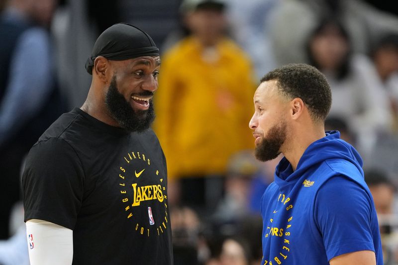 Dec 25, 2024; San Francisco, California, USA; Los Angeles Lakers forward LeBron James (left) and Golden State Warriors guard Stephen Curry (right) talk before the game at Chase Center. Mandatory Credit: Darren Yamashita-Imagn Images