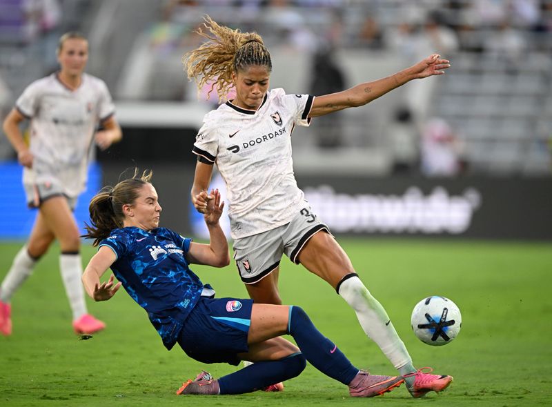 San Diego Wave midfielder Tatum Wynalda tackles Angel City FC forward Sveindís Jonsdottir during the second half of a NWSL match at Snapdragon Stadium on July 11. Angel City won, 2-0.