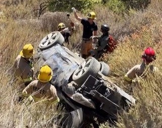 Authorities said one adult died and two were critically injured after their vehicle left Interstate 15 and traveled down a steep embankment in the Cajon Pass.