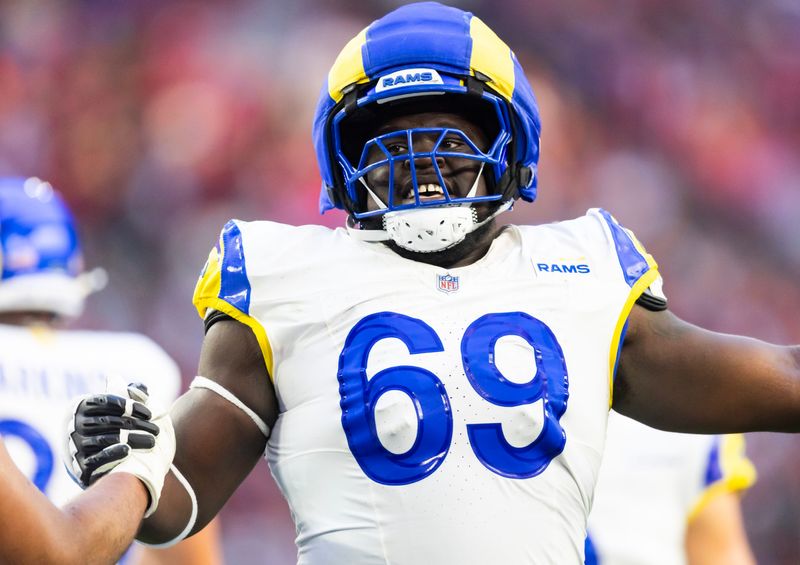 Dec 7, 2025; Glendale, Arizona, USA; Los Angeles Rams  offensive lineman Kevin Dotson (69) against the Arizona Cardinals at State Farm Stadium. Mandatory Credit: Mark J. Rebilas-Imagn Images