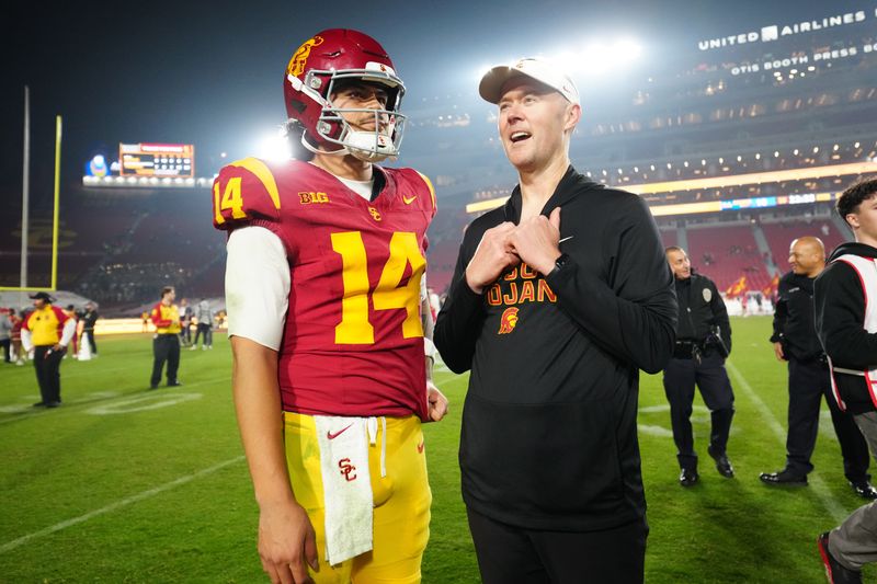Nov 29, 2025; Los Angeles, California, USA; Southern California Trojans quarterback Jayden Maiava (14) and head coach Lincoln Riley react after the game against the UCLA Bruins at United Airlines Field at Los Angeles Memorial Coliseum. Mandatory Credit: Kirby Lee-Imagn Images