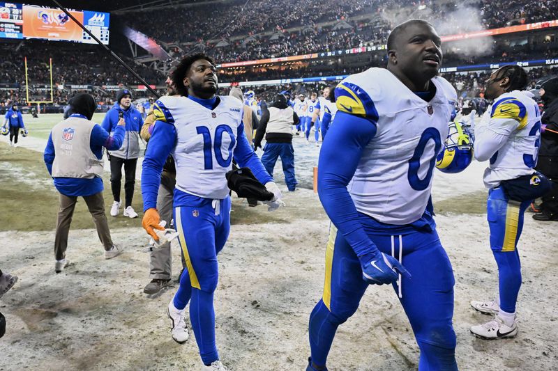 Jan 18, 2026; Chicago, IL, USA; Los Angeles Rams linebackers Josaiah Stewart (10) and Byron Young (0) leave the field after an NFC Divisional Round game against the Chicago Bears Soldier Field. Mandatory Credit: Matt Marton-Imagn Images