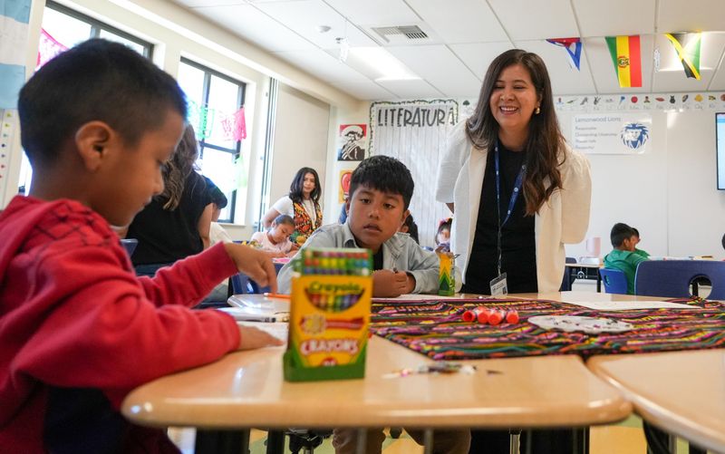 Visiting teacher Arelia Guillen of Jalisco, Mexico, right, helps students at Lemonwood Elementary School in Oxnard with artwork on July 21, 2026. It's part of a county program for children of migrant farm workers.