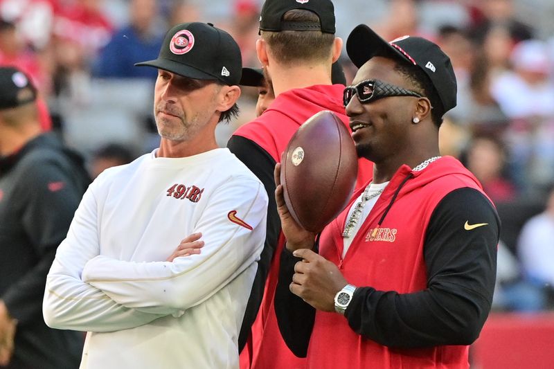 Jan 5, 2025; Glendale, Arizona, USA; San Francisco 49ers head coach Kyle Shanahan (left) and wide receiver Deebo Samuel Sr. (right) look on prior to the game against the Arizona Cardinals at State Farm Stadium. Mandatory Credit: Matt Kartozian-Imagn Images