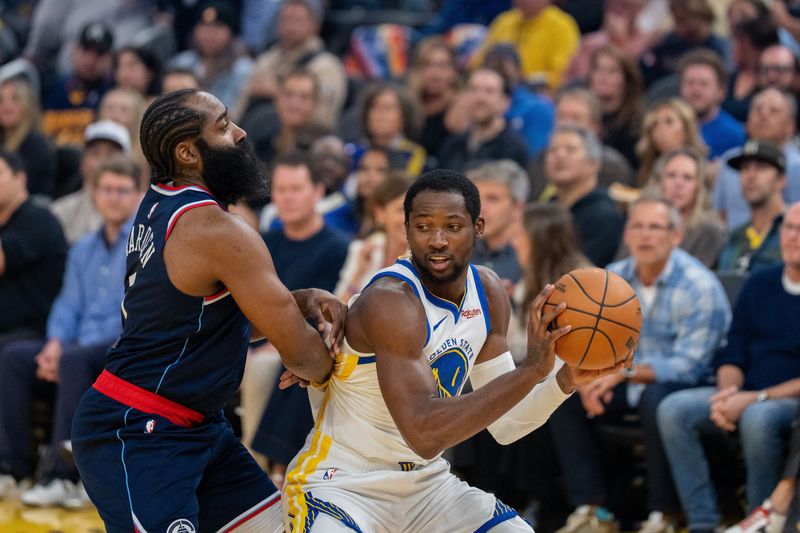 Oct 28, 2025; San Francisco, California, USA; Golden State Warriors forward Jonathan Kuminga (1) and LA Clippers guard James Harden (1) battle for position during the first quarter at Chase Center. Mandatory Credit: Neville E. Guard-Imagn Images