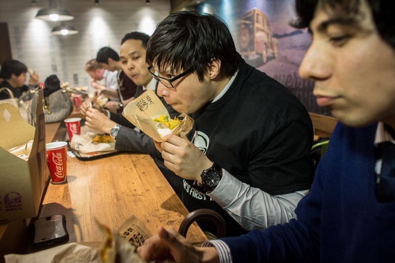 Diners enjoy their meals inside the new Taco Bell store during the official opening on April 21, 2015 in Tokyo, Japan. The new store operated by Asrapport Dining Co. is the first store to be opened in Japan in 20 years. The Mexican-themed fast food chain entered the Japanese market in the 1980's but pulled out due to poor sales, operating stores only on restricted U.S military bases.