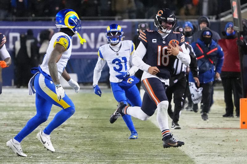 Jan 18, 2026; Chicago, IL, USA; Chicago Bears quarterback Caleb Williams (18) runs with the ball against Los Angeles Rams cornerback Darious Williams (31) during the fourth quarter of an NFC Divisional Round game at Soldier Field. Mandatory Credit: David Banks-Imagn Images