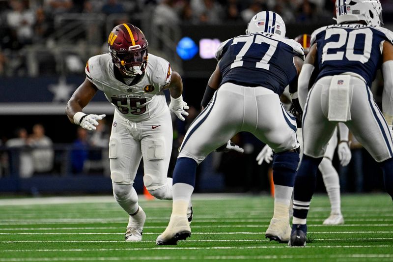 Nov 23, 2023; Arlington, Texas, USA; Washington Commanders defensive end KJ Henry (55) and Dallas Cowboys offensive tackle Tyron Smith (77) in action during the game between the Dallas Cowboys and the Washington Commanders at AT&T Stadium. Mandatory Credit: Jerome Miron-USA TODAY Sports