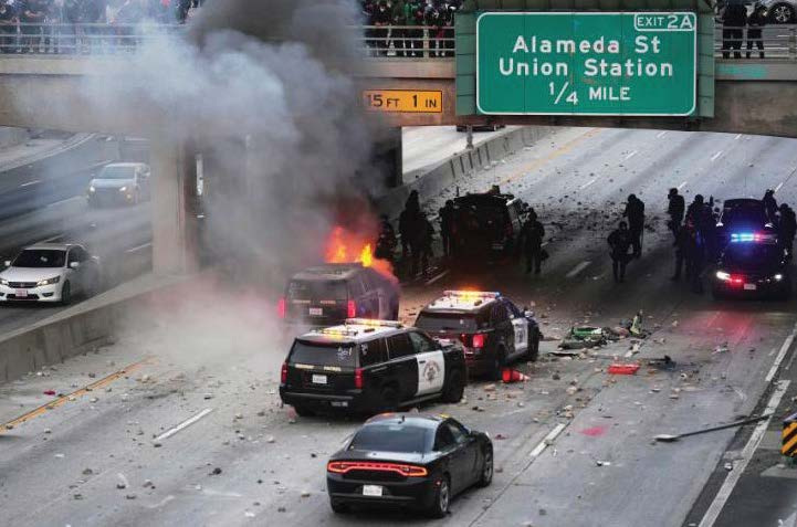 A California Highway Patrol vehicle catches fire under a Highway 101 overpass during an anti-ICE protest on June 8, 2025. A Westlake Village man was sentenced to over three years in prison on July 27, 2026 for his involvement in the incident.