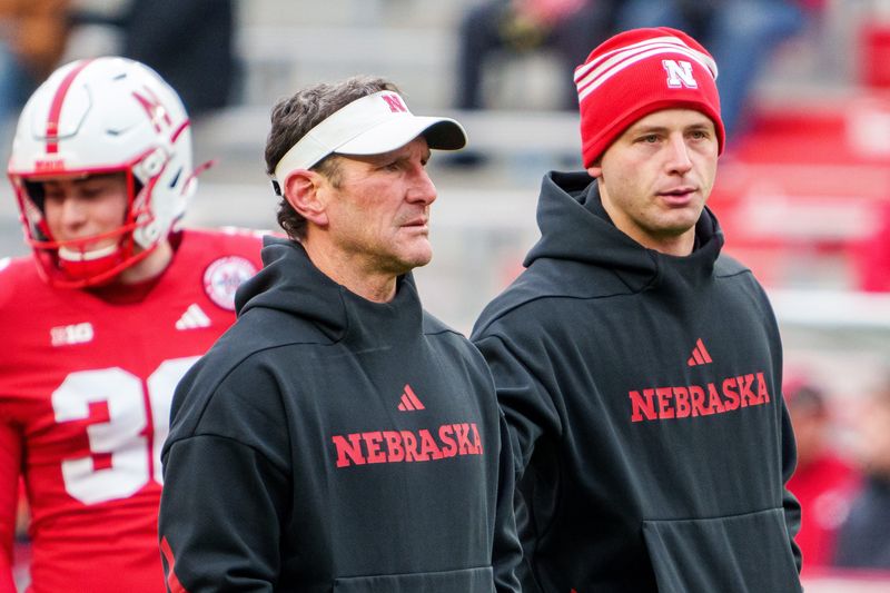Nov 28, 2025; Lincoln, Nebraska, USA; Nebraska Cornhuskers assistant coach Mike Ekeler (left) watches warmups before the game against the Iowa Hawkeyes at Memorial Stadium. Mandatory Credit: Dylan Widger-Imagn Images
