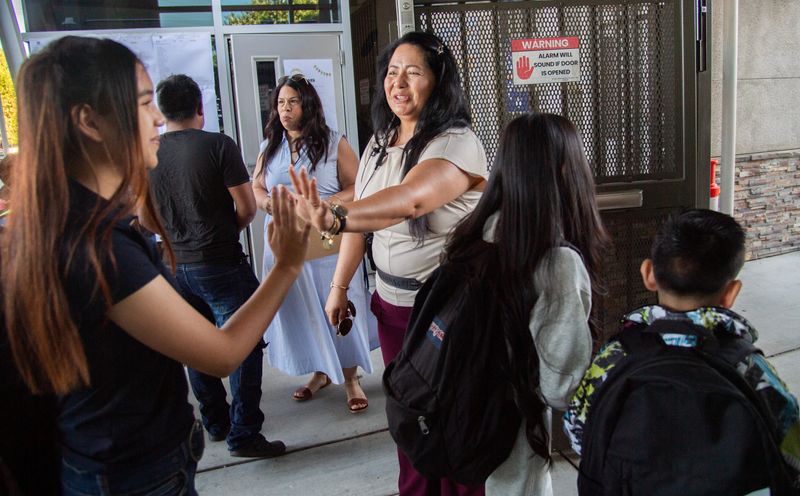 Assistant principal Angelica Ibarra greets students on the first day of instruction at Spanos Elementary School in Stockton on Jul. 30, 2026.