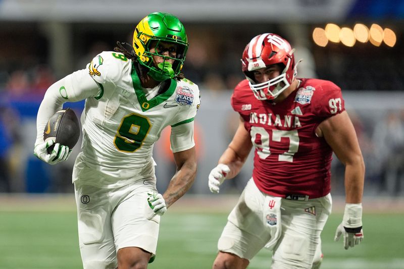 Jan 9, 2026; Atlanta, GA, USA; Oregon Ducks tight end Jamari Johnson (9) runs the ball against Indiana Hoosiers defensive lineman Mario Landino (97) during the fourth quarter the 2025 Peach Bowl and semifinal game of the College Football Playoff at Mercedes-Benz Stadium. Mandatory Credit: Dale Zanine-Imagn Images