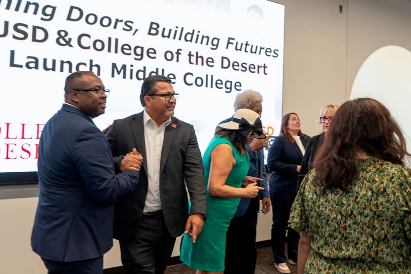 Palm Springs Unified Superintendent Marcus Funchess, left, and College of the Desert President/Superintendent Val Martinez Garcia shake hands after announcing a partnership July 30 to open the Coachella Valley's first "middle college" high school.