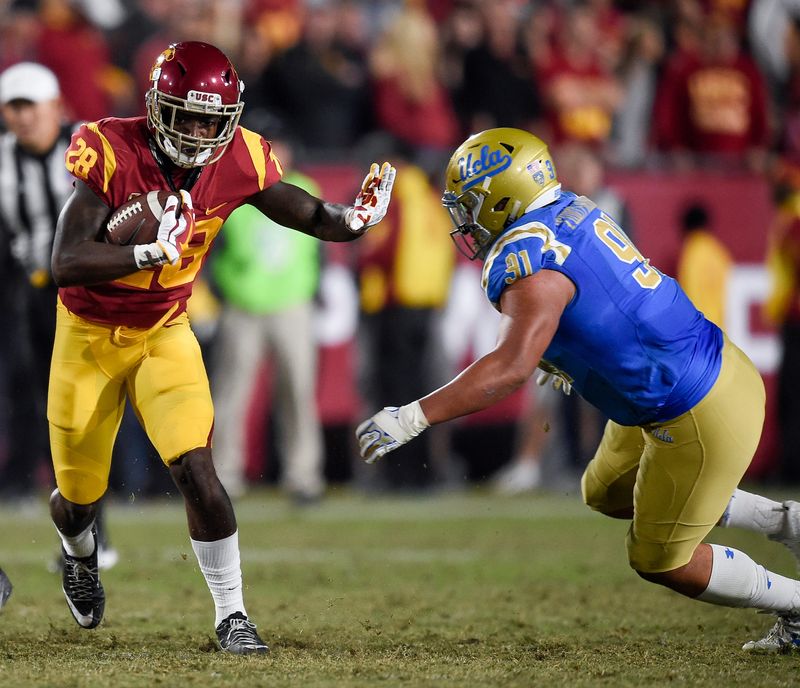 Nov 18, 2017; Los Angeles, CA, USA; Southern California Trojans running back Aca'Cedric Ware (28) runs the ball defended by UCLA Bruins defensive lineman Jacob Tuioti-Mariner (91) during the second half at Los Angeles Memorial Coliseum. Mandatory Credit: Kelvin Kuo-USA TODAY Sports