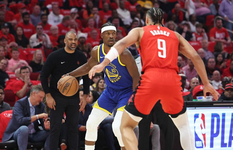 Apr 20, 2025; Houston, Texas, USA; Golden State Warriors forward Jimmy Butler III (10) controls the ball as Houston Rockets forward Dillon Brooks (9) defends during the first quarter at Toyota Center. Mandatory Credit: Troy Taormina-Imagn Images