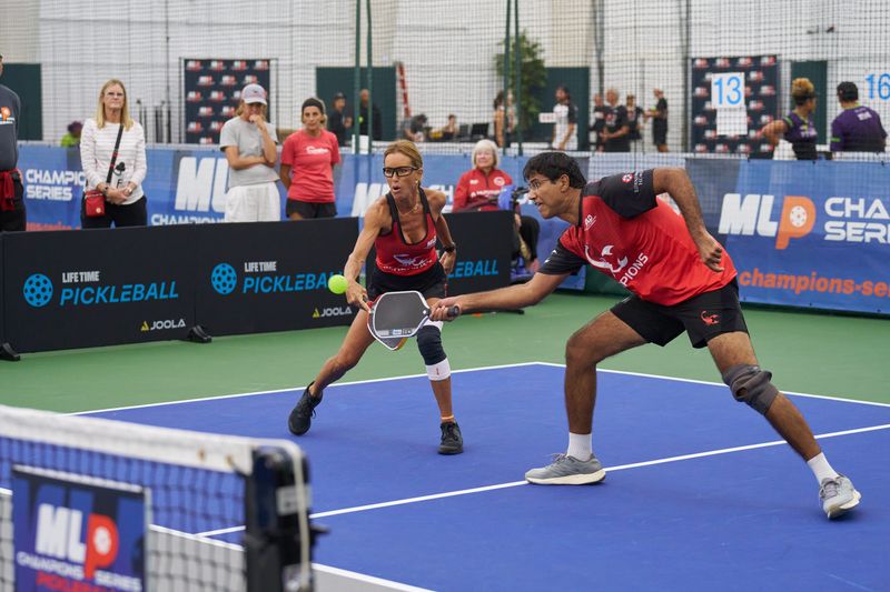 Dhruv Manchanda (right) and Drita Rosen of the Coachella Valley Scorpions both lunge for the ball in a mixed-doubles match Friday, Aug. 1, 2026.