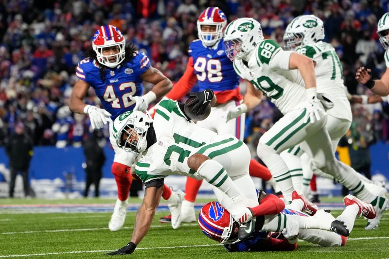 Jan 4, 2026; Orchard Park, New York, USA; New York Jets running back Khalil Herbert (31) carries the ball against the Buffalo Bills during the third quarter at Highmark Stadium. Mandatory Credit: Gregory Fisher-Imagn Images