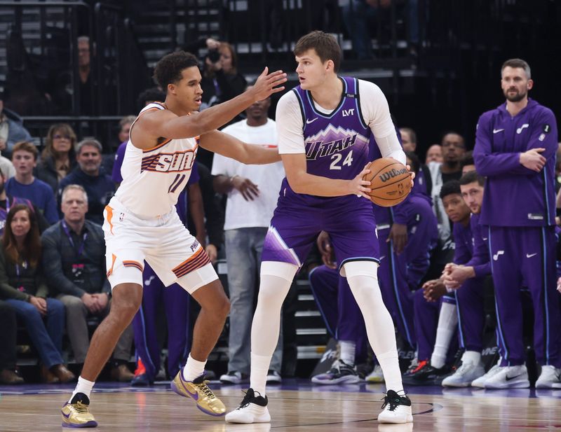 Oct 27, 2025; Salt Lake City, Utah, USA; Utah Jazz center Walker Kessler (24) looks to pass against Phoenix Suns forward Oso Ighodaro (11) during the first quarter at Delta Center. Mandatory Credit: Rob Gray-Imagn Images