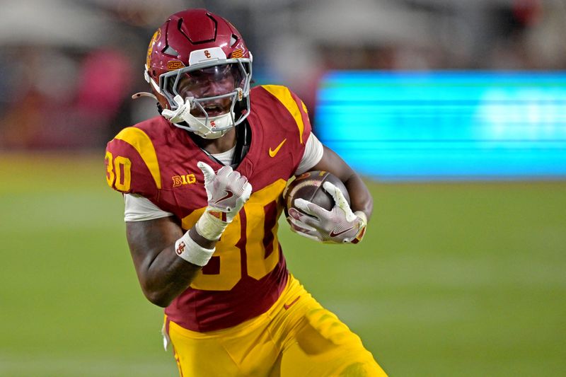 Oct 11, 2025; Los Angeles, California, USA; USC Trojans running back King Miller (30) runs for a touchdown in the second half against the Michigan Wolverines at United Airlines Field at the Los Angeles Memorial Coliseum. Mandatory Credit: Jayne Kamin-Oncea-Imagn Images