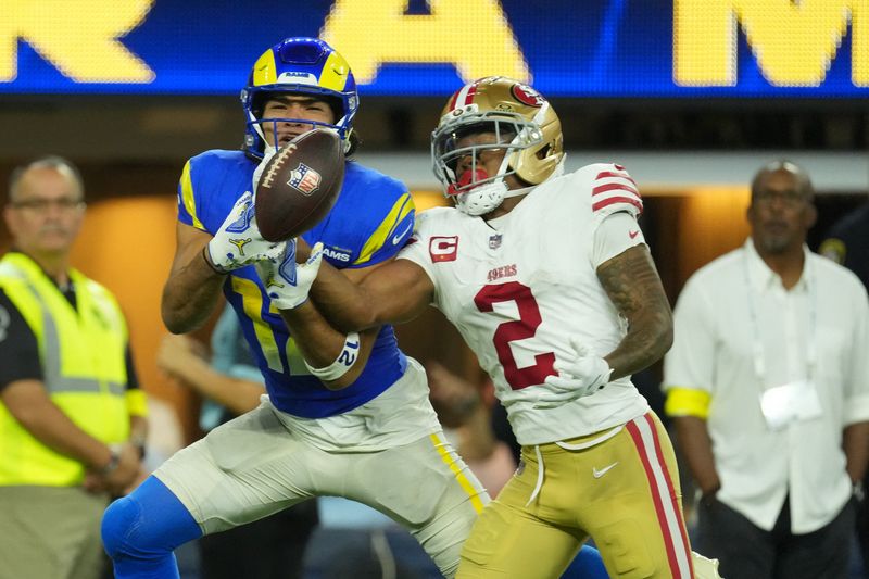 Oct 2, 2025; Inglewood, California, USA; Los Angeles Rams wide receiver Puka Nacua (12) attempts to make a catch against San Francisco 49ers cornerback Deommodore Lenoir (2) during the second half at SoFi Stadium. Mandatory Credit: Kirby Lee-Imagn Images