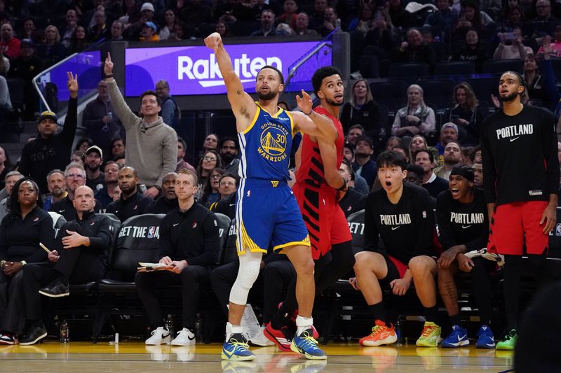 Jan 13, 2026; San Francisco, California, USA;  Golden State Warriors guard Stephen Curry (30) shoots a jumpshot while defended by Portland Trail Blazers forward Toumani Camara (33) in the third quarter at Chase Center. Mandatory Credit: David Gonzales-Imagn Images