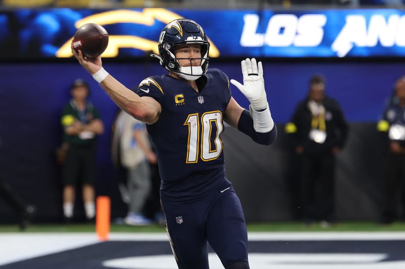 Dec 27, 2025; Inglewood, California, USA;  Los Angeles Chargers quarterback Justin Herbert (10) throws a pass against the Houston Texans during the second half at SoFi Stadium. Mandatory Credit: Kiyoshi Mio-Imagn Images