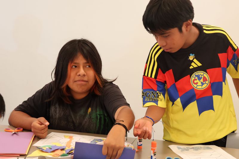 Esmeralda Vivar, 13, from left, and her brother Ivan Vivar, 11, work on crafts in the eight-week Summer to Remember program in their Oxnard housing community Aug. 4.