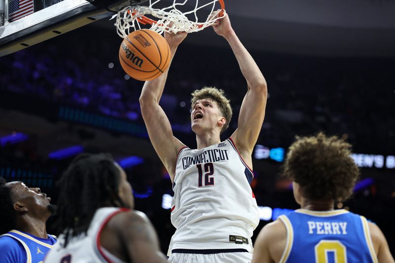 Mar 22, 2026; Philadelphia, PA, USA; UConn Huskies center Eric Reibe (12) dunks the ball against the UCLA Bruins in the first half during a second round game of the men's 2026 NCAA Tournament at Xfinity Mobile Arena. Mandatory Credit: Bill Streicher-Imagn Images