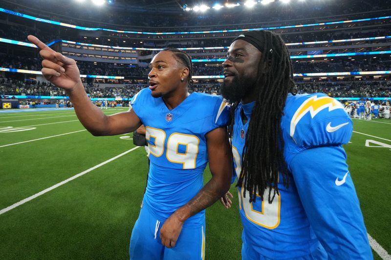 Dec 8, 2025; Inglewood, California, USA; Los Angeles Chargers cornerback Tarheeb Still (29) and cornerback Donte Jackson (26) celebrate after defeating the Philadelphia Eagles in overtime at SoFi Stadium. Mandatory Credit: Kirby Lee-Imagn Images