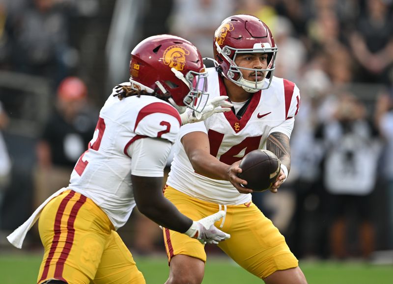 Sep 13, 2025; West Lafayette, Indiana, USA; Southern California Trojans quarterback Jayden Maiava (14) hands off the ball to Southern California Trojans running back Waymond Jordan (2) during the first quarter at Ross-Ade Stadium. Mandatory Credit: Marc Lebryk-Imagn Images