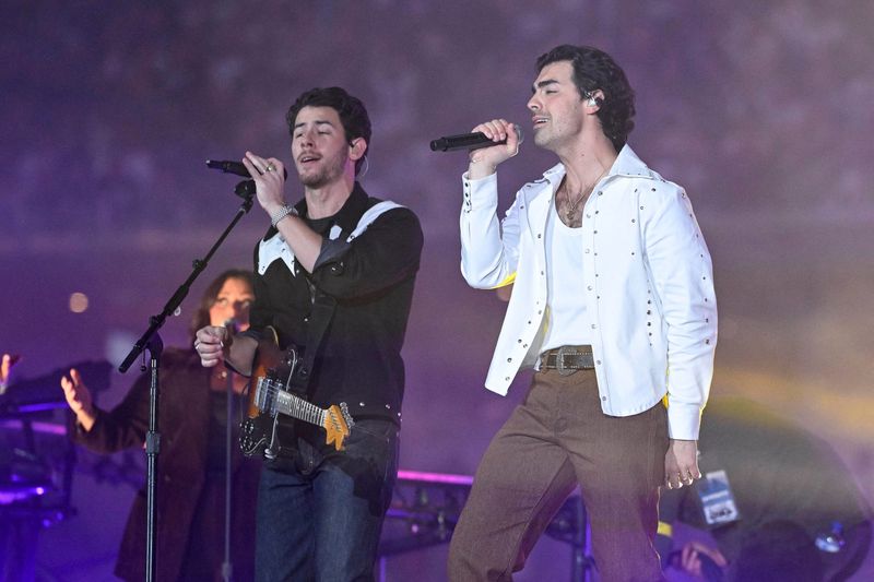 Nov 24, 2022; Arlington, Texas, USA; The music group the Jonas Brothers perform during halftime of the game between the Dallas Cowboys and the New York Giants at AT&T Stadium. Mandatory Credit: Jerome Miron-USA TODAY Sports